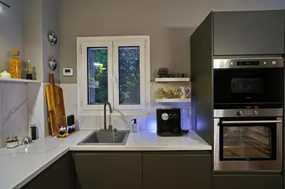 a kitchen with a sink and a microwave at Five Seasons Alimos in Athens