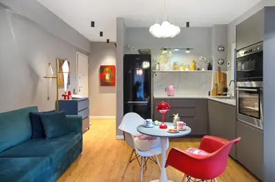 a living room with a couch and a table with chairs at Five Seasons Alimos in Athens