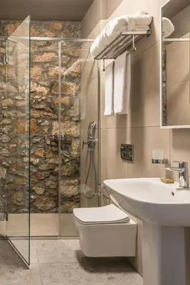 a bathroom with a shower and a toilet and a sink at Cohort Koukaki in Athens