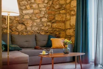 a living room with a couch and a table at Cohort Koukaki in Athens