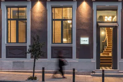 a person walking in front of a building at Cohort Koukaki in Athens