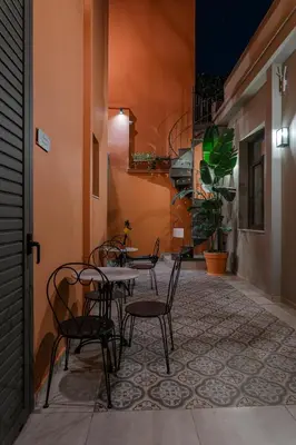 a patio with tables and chairs in a building at Vagabond Guesthouse in Athens