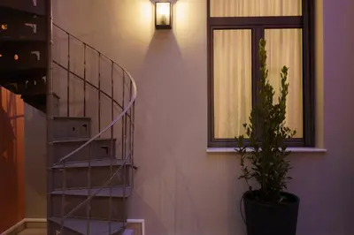 a staircase with a potted plant next to a window at Vagabond Guesthouse in Athens