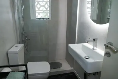 a bathroom with a sink and a toilet and a shower at Comfy studio apartment very close to city centre in Athens