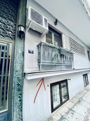 a building with a balcony and a air conditioner on it at Comfy studio apartment very close to city centre in Athens