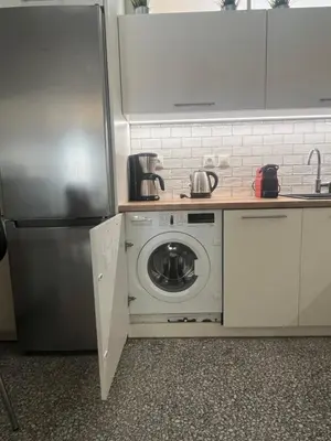a kitchen with a washing machine and a refrigerator at 2 Bedroom Acropolis Apartment in Athens