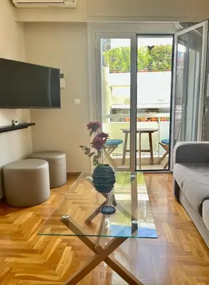 a living room with a glass table and a couch at 2 Bedroom Acropolis Apartment in Athens