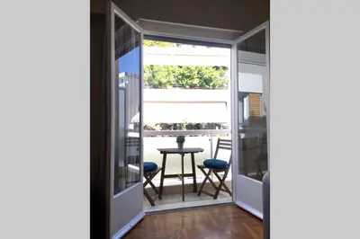 a room with a balcony with a table and chairs at 2 Bedroom Acropolis Apartment in Athens