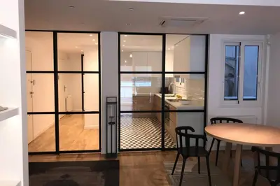 a room with glass doors and a table and a kitchen at Luxury 2 bedroom 2 bathroom flat in Kolonaki ! in Athens