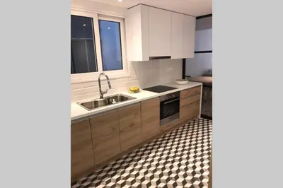 a kitchen with white cabinets and a sink at Luxury 2 bedroom 2 bathroom flat in Kolonaki ! in Athens