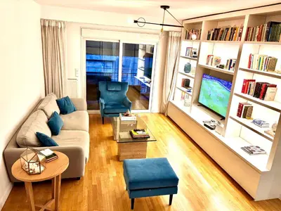 a living room with a couch and a tv at Luxury 2 bedroom 2 bathroom flat in Kolonaki ! in Athens
