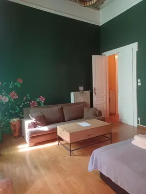 a living room with a couch and a coffee table at The monumental house in Athens