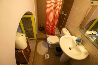 a small bathroom with a sink and a toilet at The monumental house in Athens