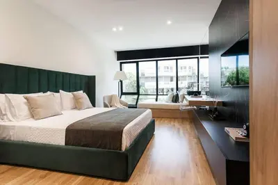 a bedroom with a large bed and a large window at 2 SidebySide Suites in Athens Riviera by The Olon in Athens