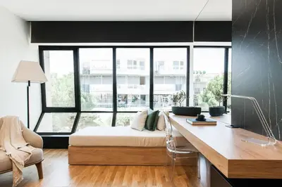 a bedroom with a bed and a desk in a room at 2 SidebySide Suites in Athens Riviera by The Olon in Athens