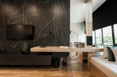 a living room with a desk and a tv on a wall at 2 SidebySide Suites in Athens Riviera by The Olon in Athens