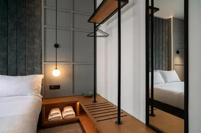a bedroom with two beds and a mirror at Bob W Athens Akadimia in Athens