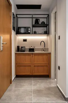 a kitchen with wooden cabinets and a sink at Bob W Athens Akadimia in Athens