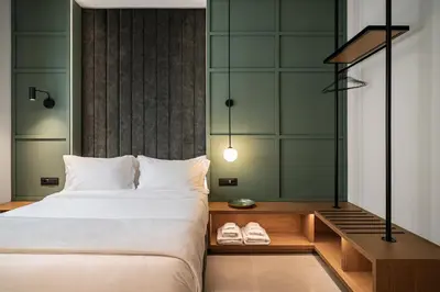 a bedroom with a large bed and two slippers at Bob W Athens Akadimia in Athens