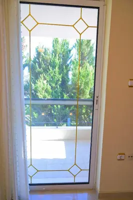 a glass door with a view of a patio at GREEN PARADISE PALAIA FoKAIA in Áyios Yeóryios