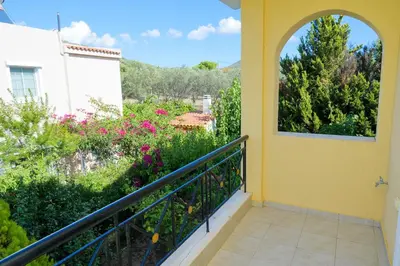 a balcony with a view of a garden at GREEN PARADISE PALAIA FoKAIA in Áyios Yeóryios