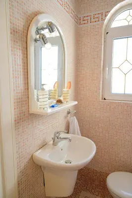 a bathroom with a sink and a mirror at GREEN PARADISE PALAIA FoKAIA in Áyios Yeóryios