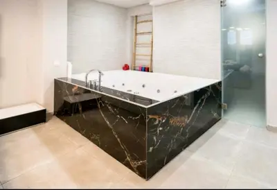 a bathroom with a bath tub and a sink at DELUXE ROMANTIC JACUZZI in Athens