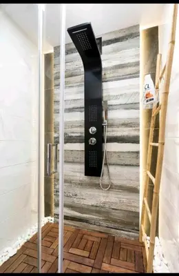 a shower in a bathroom with a wall at DELUXE ROMANTIC JACUZZI in Athens