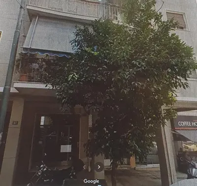 a tree is in front of a building at DELUXE ROMANTIC JACUZZI in Athens