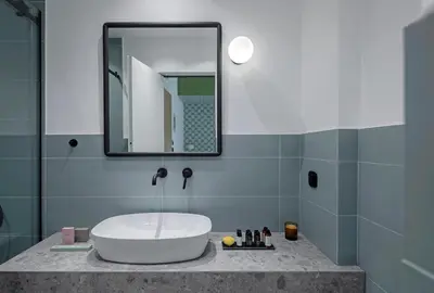a bathroom with a sink and a mirror at Acro Urban Suites in Athens