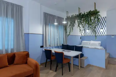 a living room with a table and a couch at Acro Urban Suites in Athens