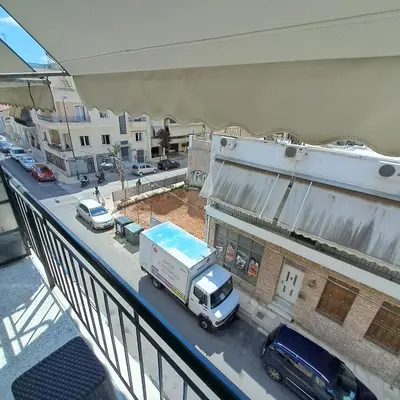 a truck is parked on a city street at Teros apartment in Athens