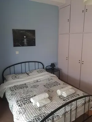 a bedroom with a bed with two towels on it at Teros apartment in Athens