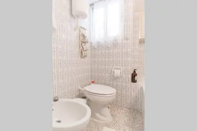 a white bathroom with a toilet and a sink at Spacious and Luxurious Apart Athens Center by MPS in Athens
