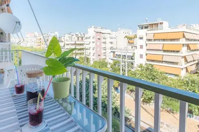 a potted plant sitting on a balcony with a view of a city at Spacious and Luxurious Apart Athens Center by MPS in Athens