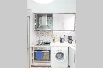 a kitchen with a washing machine and a washer at Spacious and Luxurious Apart Athens Center by MPS in Athens