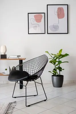 a black chair in a room with a plant at Ideal 1 BR Apartment in Petralona by UPSTREET in Athens