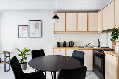 a kitchen with a table and chairs in a kitchen at Ideal 1 BR Apartment in Petralona by UPSTREET in Athens