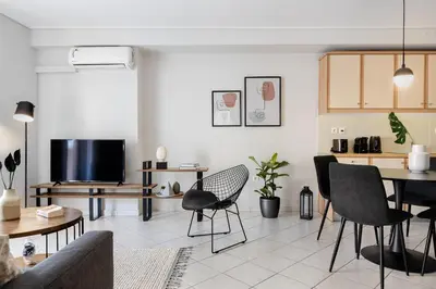 a living room with a couch and a table at Ideal 1 BR Apartment in Petralona by UPSTREET in Athens