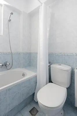 a bathroom with a toilet and a tub and a sink at Ideal 1 BR Apartment in Petralona by UPSTREET in Athens