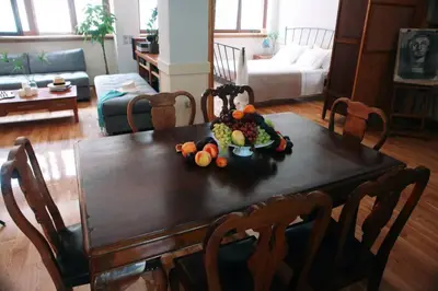 a wooden table with a bowl of fruit on it at Unique - Spacious Studio with rooftop / Thissio in Athens