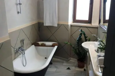 a bathroom with a bath tub and a sink at Unique - Spacious Studio with rooftop / Thissio in Athens