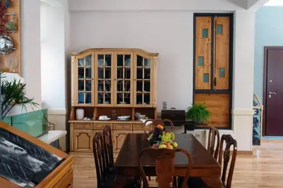 a dining room with a table and a china cabinet at Unique - Spacious Studio with rooftop / Thissio in Athens