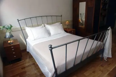 a bedroom with a large bed with white sheets and pillows at Unique - Spacious Studio with rooftop / Thissio in Athens