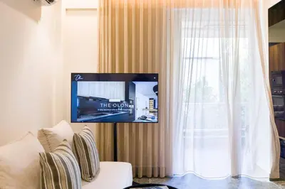 a living room with a white couch and a window at Luxury Apt near the Beach Athens Riviera by Olon in Athens