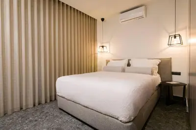 a bedroom with a white bed in a room at Luxury Apt near the Beach Athens Riviera by Olon in Athens