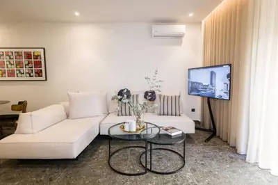 a living room with a white couch and a table at Luxury Apt near the Beach Athens Riviera by Olon in Athens