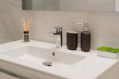 a bathroom sink with two cups and a faucet at Kolonaki Luxury Residence in Athens
