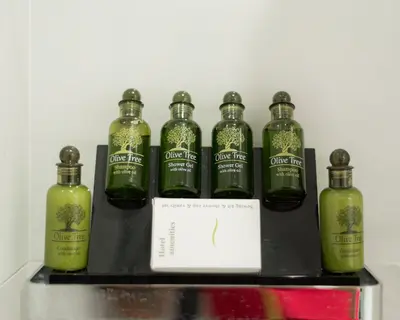 a group of green bottles on a black shelf at Kolonaki Luxury Residence in Athens