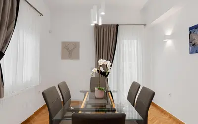 a dining room with a glass table and chairs at Kolonaki Luxury Residence in Athens